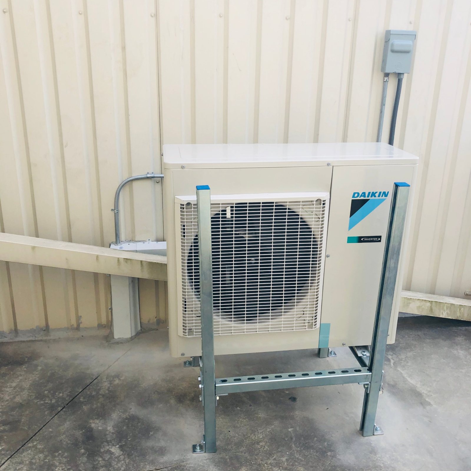 Daikin inverter condenser on a bolted galvanized Unistrut stand with capped ends in Houston