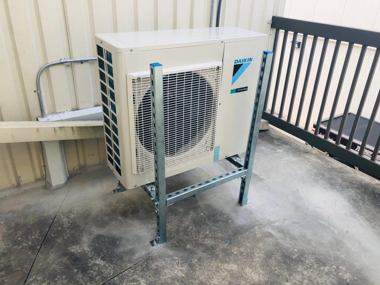 Daikin condenser on a Unistrut stand on the upper deck of a Houston self-storage building