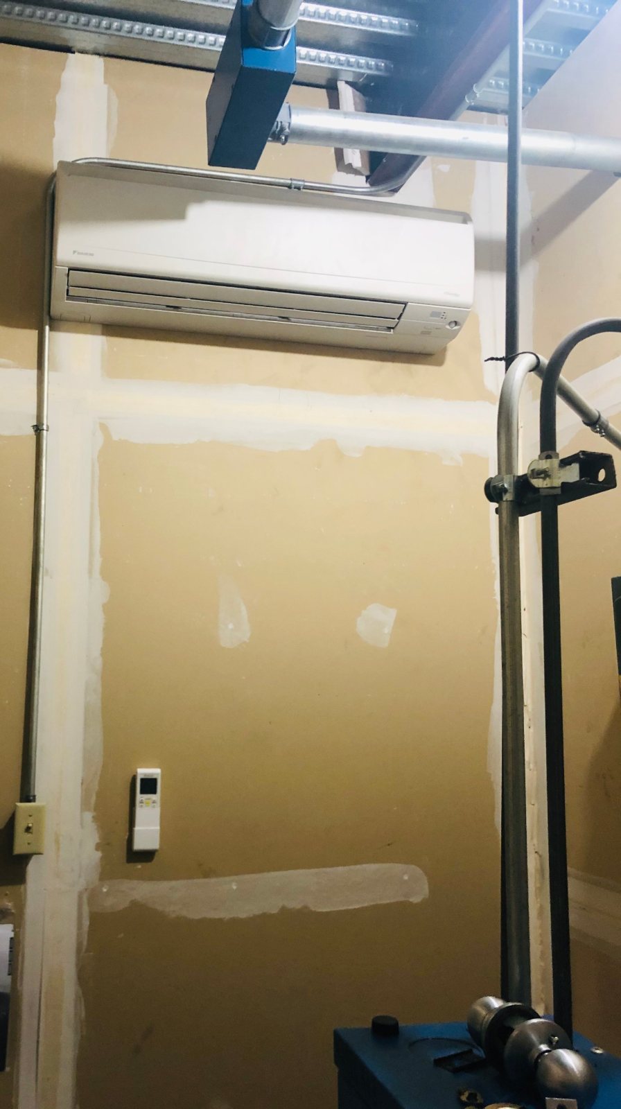 Daikin ductless wall unit cooling a self-storage elevator machine room in Houston