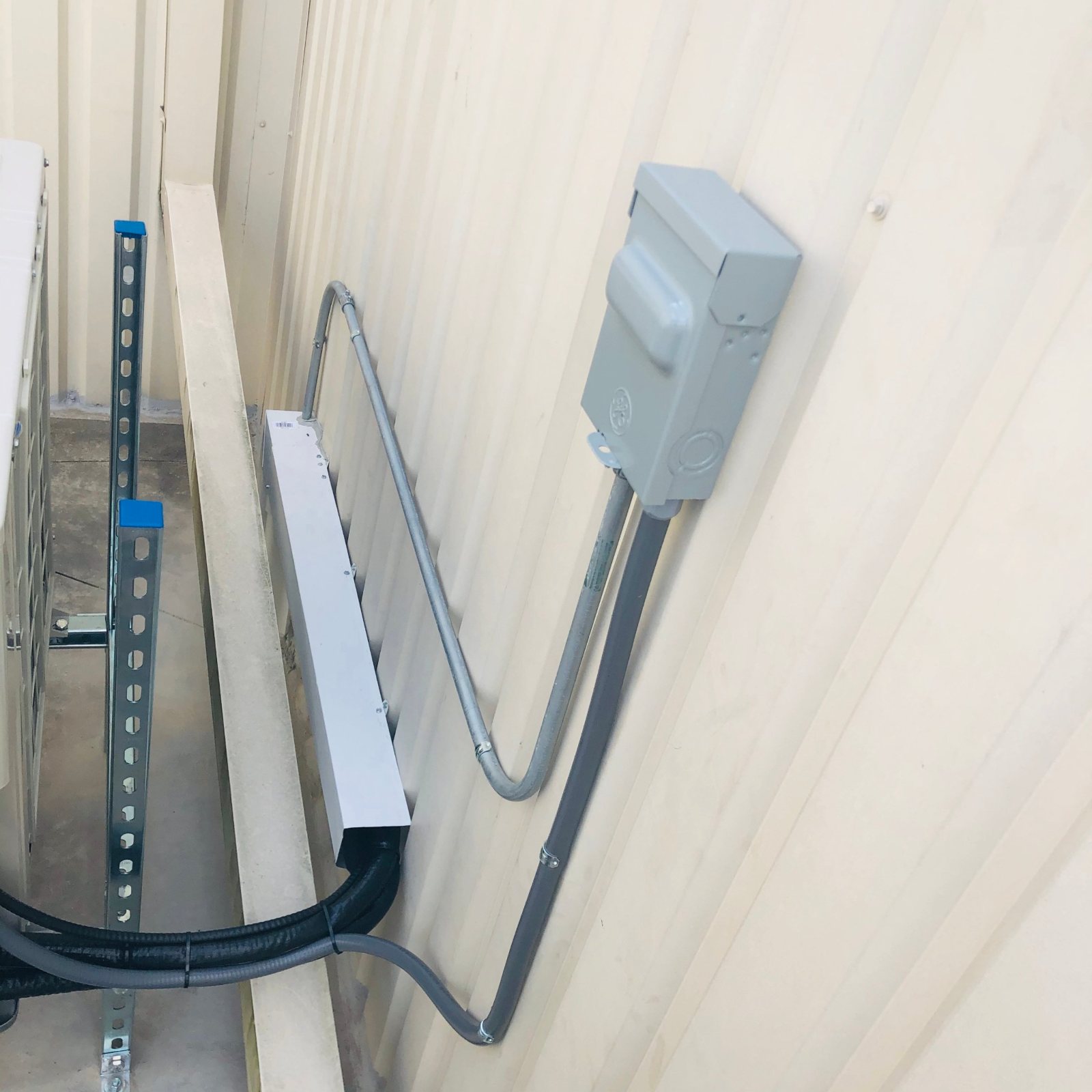 Line set cover, liquid-tight whip, and EMT conduit run to the disconnect for a Houston elevator room mini-split
