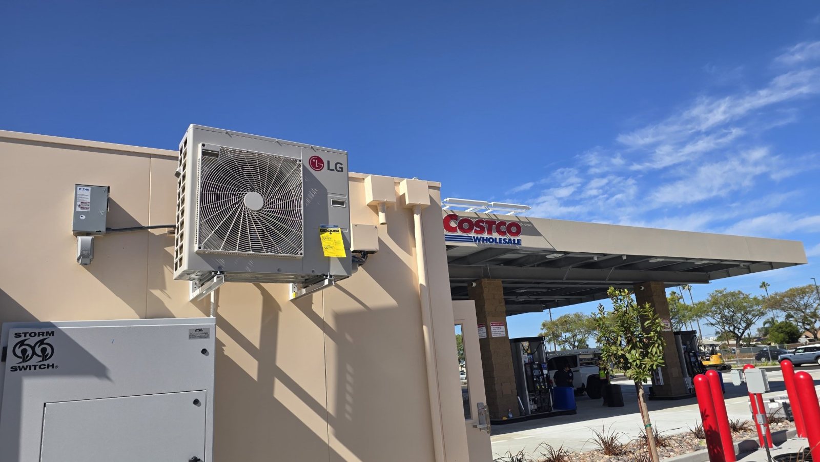 LG ductless condenser wall-mounted on a new fuel station data hut in Texas, with the fuel canopy behind it