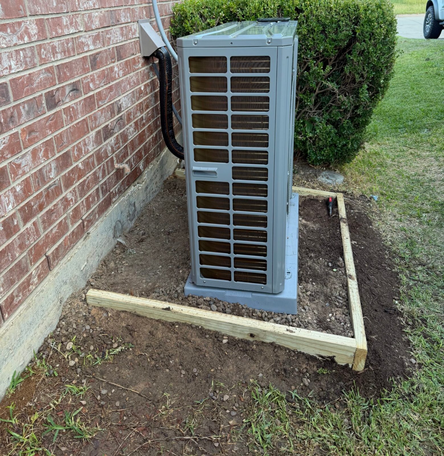 Side view of GREE outdoor unit showing coil clearance and line set in Burleson, TX