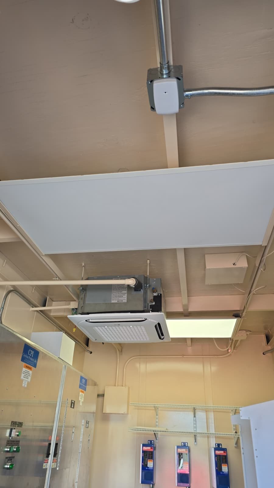 LG ceiling cassette inside a fuel station data hut above pump controllers and fueling emergency panels