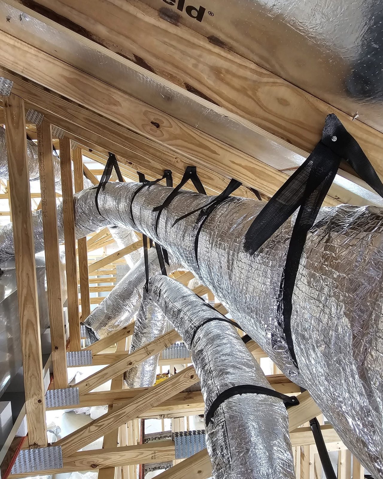 Flex duct properly strapped and supported in a new build attic
