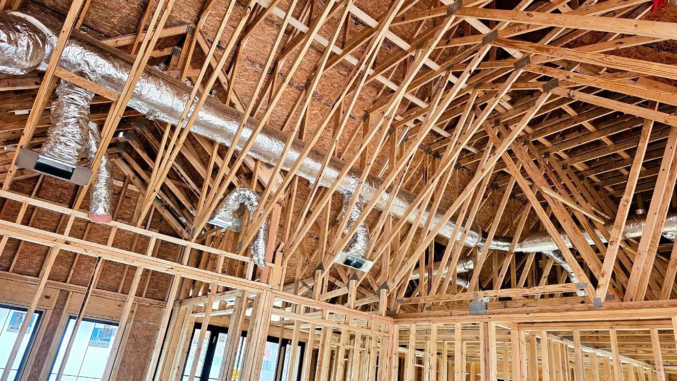 Duct trunk line and supply boots installed in new construction roof trusses