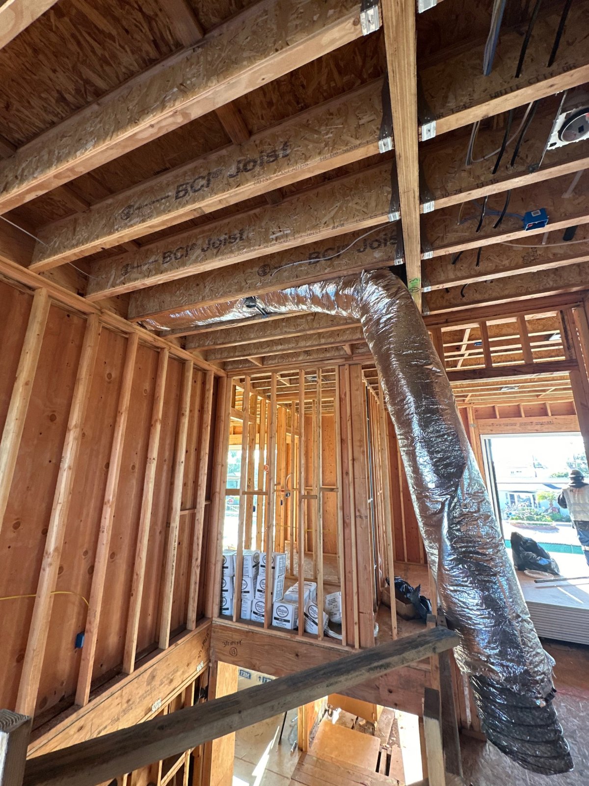New construction flex duct run through engineered floor joists