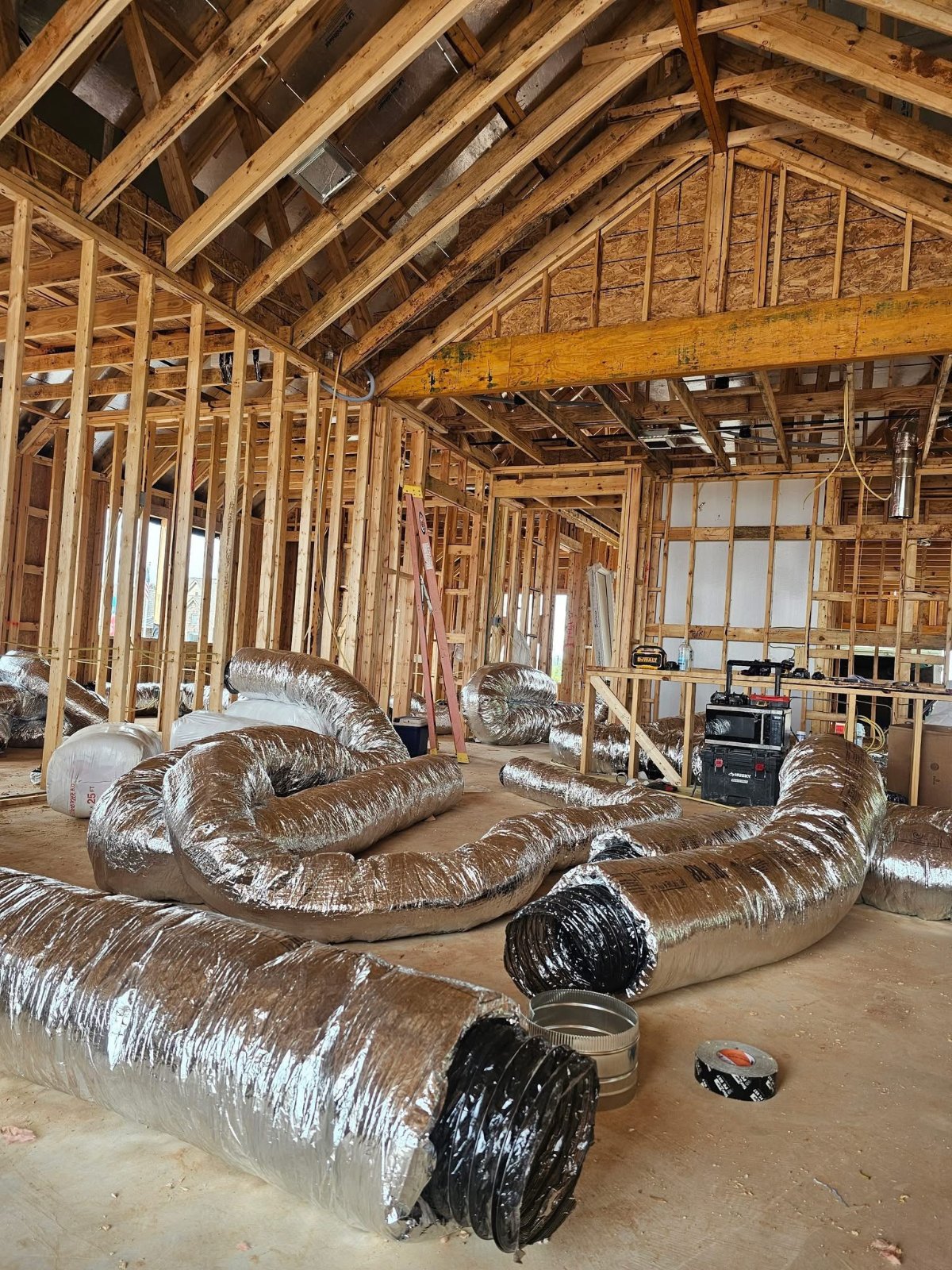 Flex duct coils staged on site for new construction HVAC rough-in