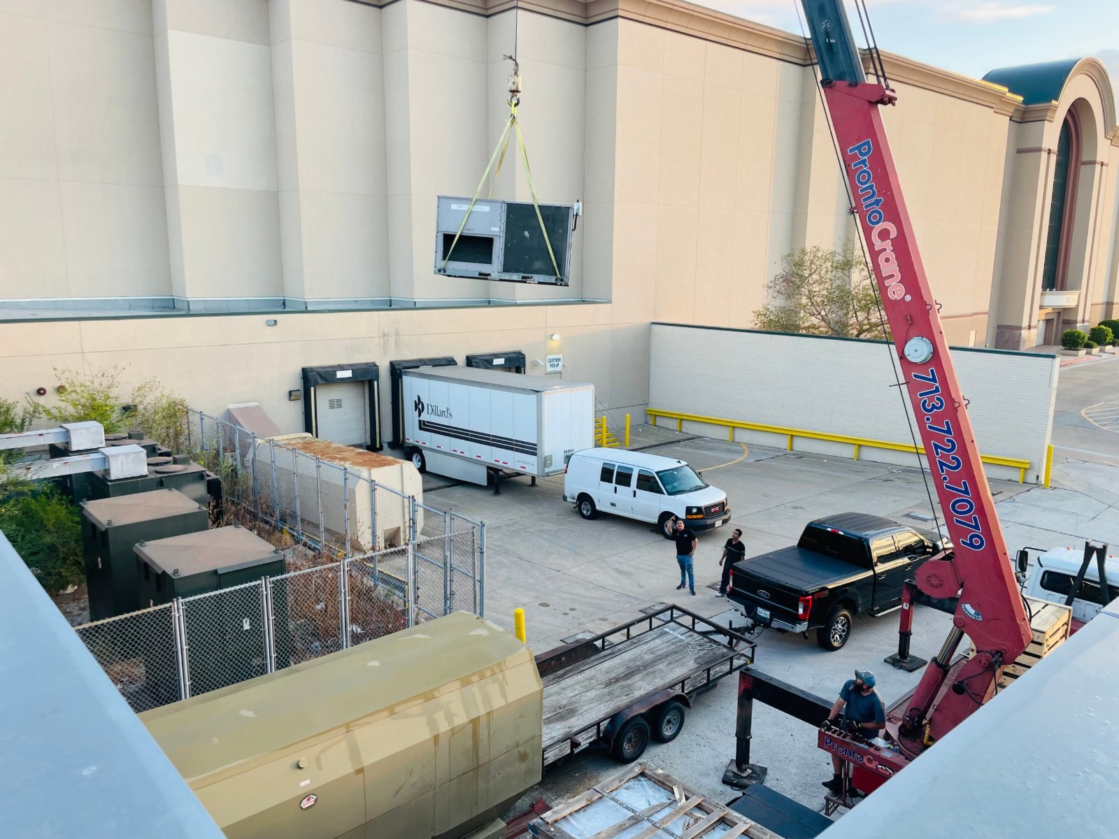 Comfort Mechanical crew working a rooftop unit crane pick from the Willowbrook Mall loading dock in Houston